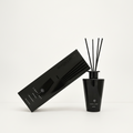 A black reed diffuser bottle with four black reeds stands next to its matching black rectangular box on a clean white background. The box and bottle are printed with the brand name 'LIGHT ART'.